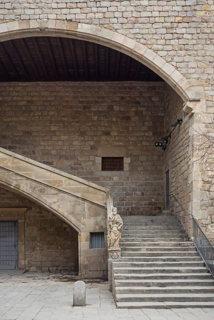 Explore the stone architecture of an ancient courtyard in Barcelona's Gothic Quarter, showcasing historic European design.