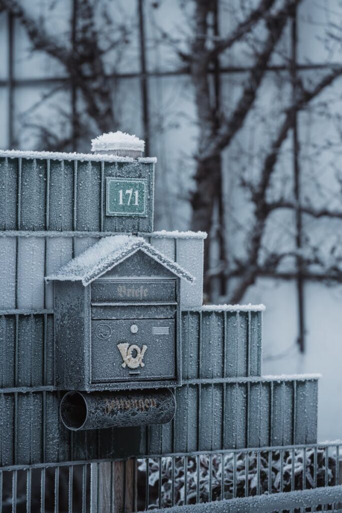 A serene winter scene featuring a frost-covered mailbox outside, conveying peace and tranquility.