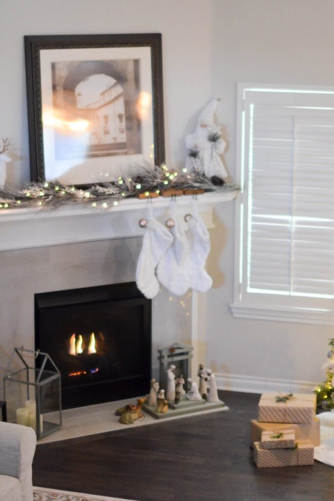 Warm and inviting living room decorated for Christmas with a beautifully lit tree and fireplace.