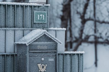 A serene winter scene featuring a frost-covered mailbox outside, conveying peace and tranquility.